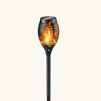 Solar garden light with flame design on a white background