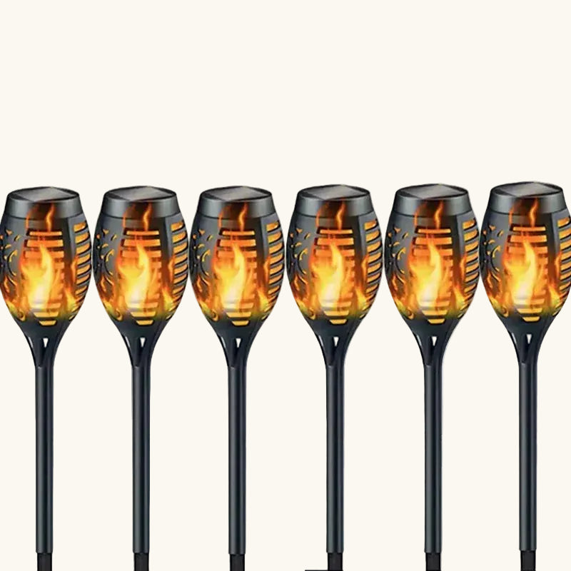 Set of six solar garden lights with flame design on a white background