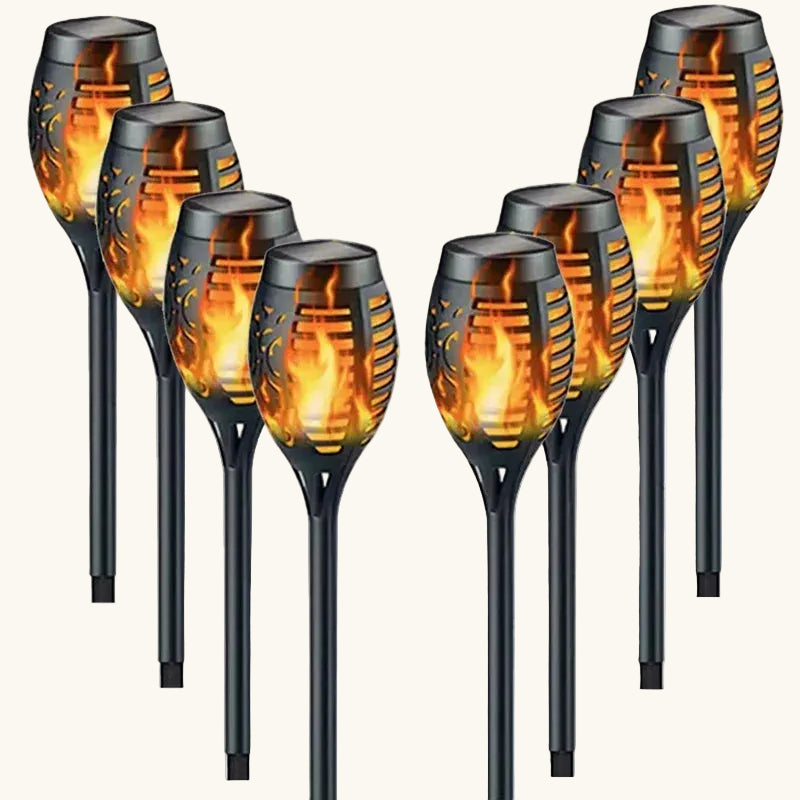 Eight solar garden lights with flame design on a white background