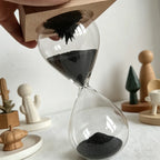 Magnetic Sand Hourglass Sculpture - Wood Base finish, in hand