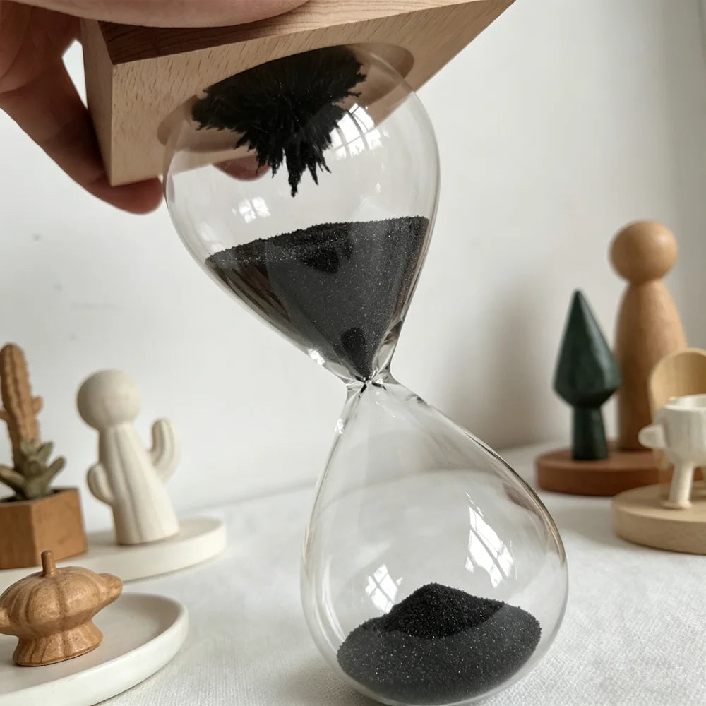 Magnetic Sand Hourglass Sculpture - Wood Base finish, in hand