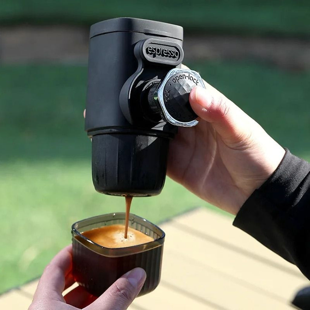 Portable hand-press espresso maker with built-in cup